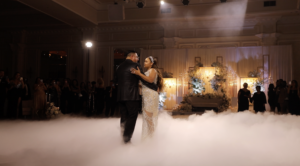 A captivating moment of a bride and groom dancing on clouds captured by wedding photography.